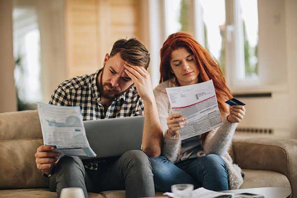 couple reviewing finances on couch